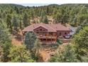 Expansive back deck and patio with seating, perfect for enjoying the serene mountain views and outdoor living at 7790 S Homesteader Dr, Morrison, CO 80465