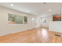 Sunlit living area showcases beautiful hardwood floors and a bright, open floor plan at 4972 W Custer Pl, Denver, CO 80219