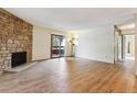 Bright living room with hardwood floors and a stone fireplace at 337 Wright St # 207, Lakewood, CO 80228