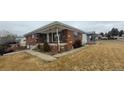 Lovely brick home with a covered front porch and a manicured lawn, perfect for a Gathering at 3601 W 80Th Ave, Westminster, CO 80031
