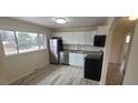 Modern kitchen featuring stainless steel appliances, sleek white cabinetry, and a spacious window for natural light at 3601 W 80Th Ave, Westminster, CO 80031