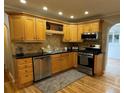 Kitchen with wood cabinets, granite countertops, and stainless steel appliances at 2670 S Hooker St, Denver, CO 80219