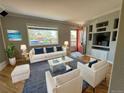 Living room features hardwood floors, a white couch, and built-in shelving at 2670 S Hooker St, Denver, CO 80219