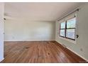 Bright living room boasts hardwood floors and natural light streaming through a large window at 7195 E Louisiana Ave, Denver, CO 80224