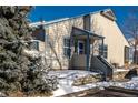 Tan exterior home with blue accents and snowy landscaping at 1869 S Union Blvd, Lakewood, CO 80228