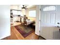 Dining room with table, chairs, hardwood floor, and view of the kitchen at 2285 S Knox Ct, Denver, CO 80219