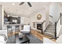 Cozy living room features a fireplace, breakfast bar seating, and staircase to the second floor at 8183 S Yosemite Ct, Centennial, CO 80112