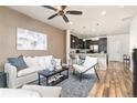 Open concept living room showing the bar seating at the kitchen counter at 8183 S Yosemite Ct, Centennial, CO 80112