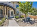 Charming home with a stone facade, manicured landscaping, and a welcoming front porch with seating area at 2235 S Cherokee St, Denver, CO 80223