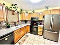 Well-lit kitchen featuring stainless steel appliances, oak cabinets, and stone countertops at 596 Trumbull Ln, Monument, CO 80132
