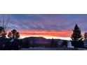 Scenic view of a vibrant sunset over the mountains and neighborhood at 596 Trumbull Ln, Monument, CO 80132