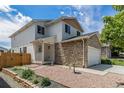 Attractive two-story home with stone accents, manicured landscaping, and a welcoming entrance at 8065 Clay St, Westminster, CO 80031