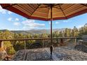 Outdoor dining set with mountain views, perfect for entertaining or enjoying a peaceful meal outdoors at 394 S Ponderosa Way, Evergreen, CO 80439