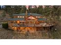 An expansive deck wraps around this home, offering multiple seating areas and breathtaking views of the surrounding landscape at 394 S Ponderosa Way, Evergreen, CO 80439