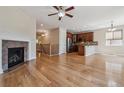 Open-concept living space featuring hardwood floors, a cozy fireplace, and abundant natural light at 13986 Lexington Dr, Parker, CO 80134