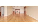 Large living room featuring hardwood floors, a stone fireplace, and custom wooden doors at 7865 E Mississippi Ave # 907, Denver, CO 80247