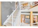 Modern staircase showcasing carpeted treads, sleek design and industrial ductwork at 396 E Warren Ave, Denver, CO 80210