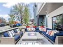 Inviting front porch with comfortable seating around a stone fire pit at 3540 Pecos St, Denver, CO 80211