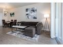 Spacious living room with L-shaped sofa and dining area at 4100 Albion St # 501, Denver, CO 80216