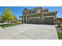 Charming two-story home with a three car garage, manicured lawn, and stone accents at 16188 Elizabeth St, Thornton, CO 80602