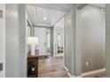 Light and bright foyer with hardwood floors and access to the office at 16188 Elizabeth St, Thornton, CO 80602