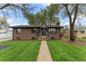 Charming brick home with a well-manicured lawn and inviting walkway at 4580 Garland St, Wheat Ridge, CO 80033
