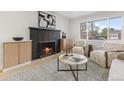 Inviting living room with a cozy fireplace, stylish furnishings, and ample natural light at 4580 Garland St, Wheat Ridge, CO 80033