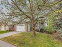 Inviting two-story home with a spacious two-car garage and mature tree at 11851 Elm Dr, Thornton, CO 80233