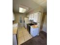 Bright kitchen with white cabinets, tiled floor, and newer appliances at 14751 E Tennessee Dr # 222, Aurora, CO 80012
