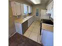 Galley style kitchen featuring white cabinets and stainless steel dishwasher at 14751 E Tennessee Dr # 222, Aurora, CO 80012