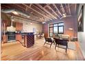 Spacious living area featuring exposed brick, hardwood floors, and an open floor plan at 1800 Lawrence St # 303, Denver, CO 80202