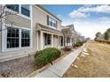 A beautiful townhome with great curb appeal featuring a sidewalk and landscaped lawn at 19709 Rosewood Ct, Parker, CO 80138