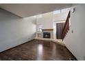 Bright living room with wood floors, a fireplace, and large windows that let in natural light at 6585 W 84Th Way # 120, Arvada, CO 80003