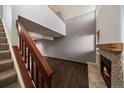 Inviting living room featuring wood floors, fireplace, and a staircase leading to the upper level at 6585 W 84Th Way # 120, Arvada, CO 80003