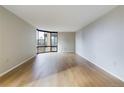 Bright living room featuring expansive windows offering city views and hardwood flooring at 1625 Larimer St # 1001, Denver, CO 80202