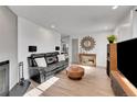 Spacious living room with hardwood flooring, fireplace, sofa, and large speakers at 16403 E Radcliff Pl # A, Aurora, CO 80015