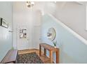 Bright entryway with wood floors and bench at 21792 Silver Meadow Ln, Parker, CO 80138