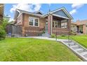 Charming brick home featuring a well-maintained lawn and inviting front porch at 3334 W 37Th Ave, Denver, CO 80211