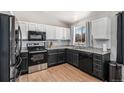 Modern kitchen featuring stainless steel appliances, granite countertops, and wood flooring at 11083 Quail Ct, Parker, CO 80134