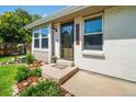Charming home entrance with brick accents, mature landscaping, and covered front entry at 18159 E Crestline Cir, Centennial, CO 80015