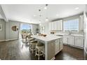 Bright kitchen with white cabinets, a central island, and stainless steel appliances at 12554 Hudson Ct, Thornton, CO 80241