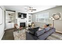 Inviting living room with a cozy fireplace, built-in shelving, and abundant natural light at 12554 Hudson Ct, Thornton, CO 80241
