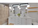 Modern bathroom featuring double sinks, pendant lighting, and sleek white cabinetry at 1726 N Lafayette St, Denver, CO 80218