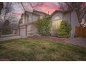 Exterior view of a charming home with a well-manicured lawn under a beautiful sunset sky at 4032 S Lisbon Way, Aurora, CO 80013