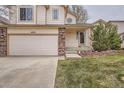 Attractive home with a two-car garage, brick accents, and mature landscaping at 4032 S Lisbon Way, Aurora, CO 80013