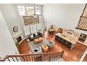 Sun-filled living room featuring a fireplace, soaring ceilings, and an open floor plan at 18315 W 83Rd Dr, Arvada, CO 80007