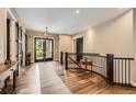 Welcoming foyer with wood floors and staircase to second level offers a grand entryway into the home at 8280 Bannock Dr, Larkspur, CO 80118