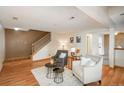 Comfortable living room with hardwood floors, a staircase, and an open layout with plenty of natural light at 8745 Yukon St # 30, Arvada, CO 80005