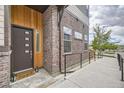Inviting entryway with a stylish front door, brick accents, and a ramp for accessibility, creating a warm welcome at 10117 Morrison Rd, Lakewood, CO 80227