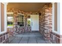 Welcoming brick-paved front porch with large windows allowing natural light at 9561 Silver Hill Cir, Lone Tree, CO 80124